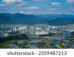 It is a view of Miryang from the mountain. It is characterized by meandering rivers, plains, and apartments everywhere. It shows a typical Korean small city.