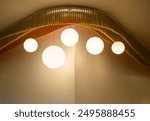 View of a modern beautiful ceiling light. Set of lamps interior with a brown wall in the modern house, The minimalist interior is decorated with circular light bulbs in warm tones 2024.
