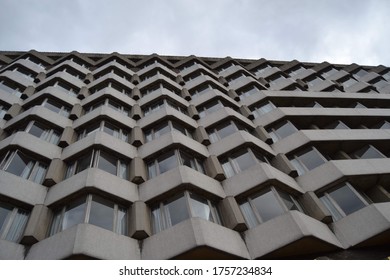 View of a modern brutalist building from its base. 