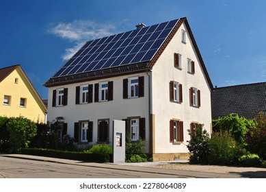 View of Modern German Country House with Roof  Covered in Solar Panels on Sunny Day   - Shutterstock ID 2278064089