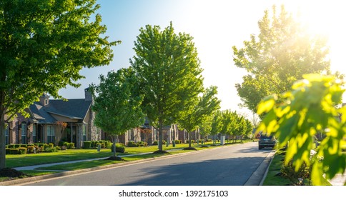 View of modern residential houses neighborhood street in Bentonville, Northwest Arkansas, sunny flare day, fast growing city lifestyle - Shutterstock ID 1392175103