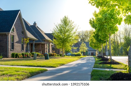 View of modern residential houses neighborhood street in Bentonville, Northwest Arkansas, sunny flare day, fast growing city lifestyle - Shutterstock ID 1392175106