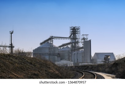 View Of Modern Sugar Factory With Industrial Silos (large Metal Tanks For Sugar, Grain Or Silage Storage), Buildings, Towers And Other Metal Structures And Equipment, Blue Sky Background
