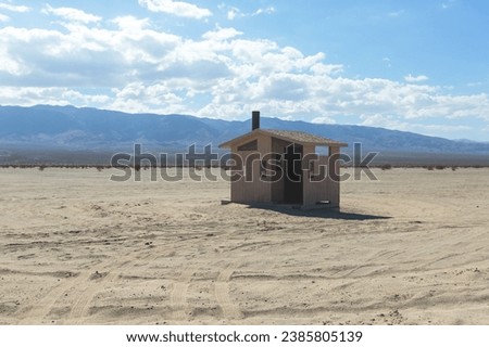 View of Mojave Desert national reserve landscape, an arid rain-shadow desert, California, United States of America, summer sunny day with road, mountains, sand dunes and a blue sky