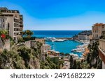 View of Monaco City with boat marina below in Monaco. Monaco City is one of the four traditional quarters.