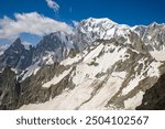 view of the mont blanc massif in the alps a snow slope covered with brown sahara dust and a rock avalanche in the background the white snow of mont blanc