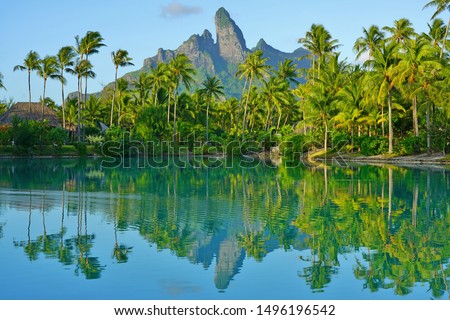 View of the Mont Otemanu mountain reflecting in water at sunset in Bora Bora, French Polynesia, South Pacific