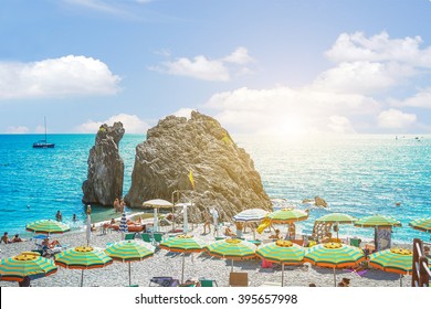 View Of Monterosso Beach With Rocks And Umbrellas - Landscape,nature,outdoor And Holiday Concept