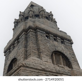 View of a monument from below, emphasizing its massive stone steps and intricate architectural details, the Völkerschlachtdenkmal.
