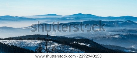 View to Moravskoslezske Beskydy mountains with Lysa hora hill from Barania Gora hill in winter Beskid Slaski mountains in Poland