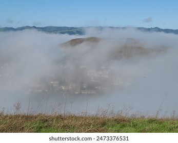 A view of the morning fog clearing out from the hills above the fog - Powered by Shutterstock