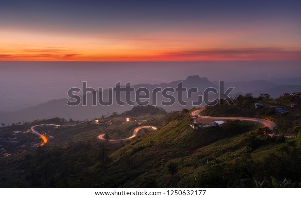 view morning\
time twilight of headlight from many cars running up to the hill on\
high way at curve road shape heart, the road shape heart of Phu Tub\
Berk, Phetchabun, Thailand\
amazing