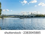 View of the Moscow river embakment, Pushkinsky bridge and cruise ships at sunset. Wide Moskva River, Pushkinsky bridge, Groky Park, Frunzenskaya embankment,