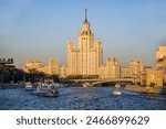 View of the Moscow River, motor ships, a high-rise building on Kotelnicheskaya embankment in the rays of the setting sun