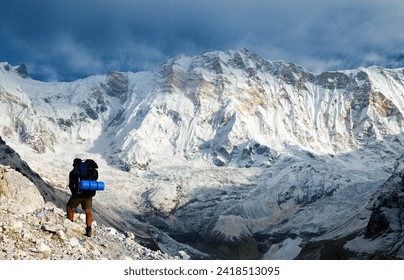 View of Mount Annapurna with hiker, round Annapurna circuit trekking trail, Annapurna south base camp, Nepal Himalayas mountains