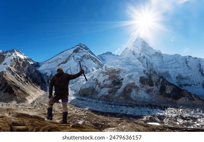 view of Mount Everest from Pumo Ri base camp and cliber with ice axe in hand blue colored, way to Everest base camp, Sagarmatha national park, Khumbu valley, Nepal himalaya mountain - Powered by Shutterstock