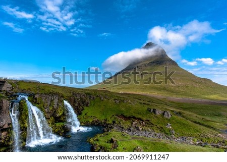view of Mount Kirkjufell and the Kirkjufellsfoss waterfall at Grundarfjordur in the Snaefellsnes peninsula in Iceland