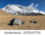 View of mount Lhotse and Nuptse South rock face and green tent, way to mt Everest base camp, Sagarmatha national park, Khumbu valley, Nepal Himalayas mountains