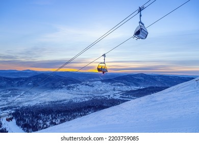 View from mount peak on Sheregesh ski resort and Altai mountains or Gornaya Shoria. Active winter rest, skiers and snowboarders on ski slope and Ski lift, beautiful nature and sport leisure.  - Powered by Shutterstock