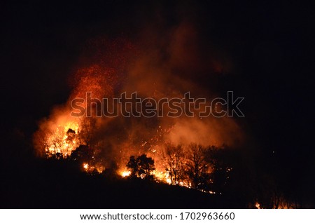 view of a mountain burning at night