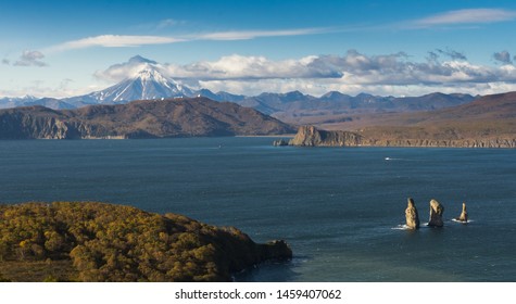 View from the mountain of the camp to the rocks Three Brothers . Vilyuchinsky volcano is located in the background. Kamchatka Peninsula .