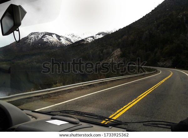 View of a\
mountain from car, route with\
landscape