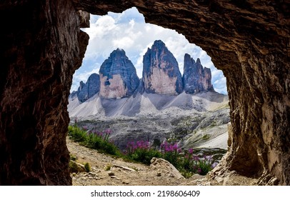 View from the mountain cave to the mountain peaks. Cave hole in mountain rock. Mountain cave entrance
