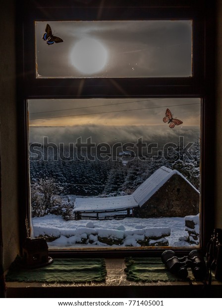 View from mountain cottage window of snow scene\
in Ireland
