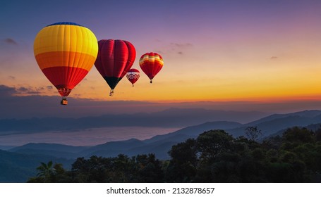 View of mountain with hot air balloons on morning. Colorful hot air balloons flying over mountain in sunrise. - Shutterstock ID 2132878657