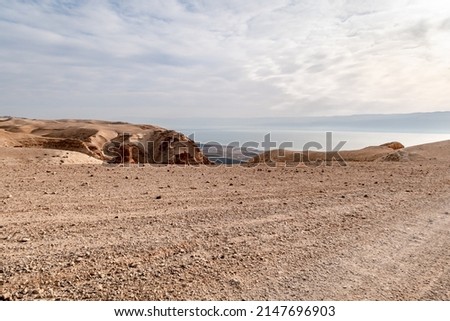 View from a mountain near the Tamarim stream on the Israeli side of the Dead Sea at sunrise over the Dead Sea and over the mountains on the Jordan side near Jerusalem in Israel