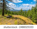 View from a mountain outcrop of the rural valley and cities of Post Falls and Stateline Idaho, part of the general Coeur d