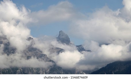 View Of A Mountain Peak Through Clouds