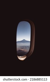 View of the mountain through the window of the plane. High quality photo