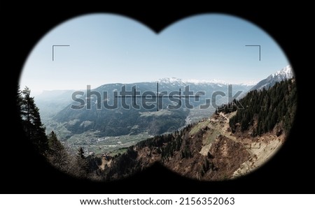 View at Mountains, alps through field glasses, binoculars. South Tyrol near Meran, in Vinschgau