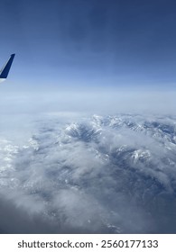 View of mountains and clouds from plane
