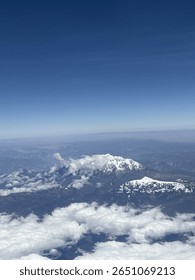 View of mountains and clouds from plane