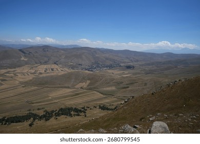 View from the mountains to the plain on the field	