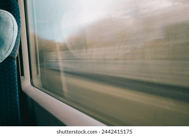 View from a moving train window with motion blur, capturing the essence of travel and speed.