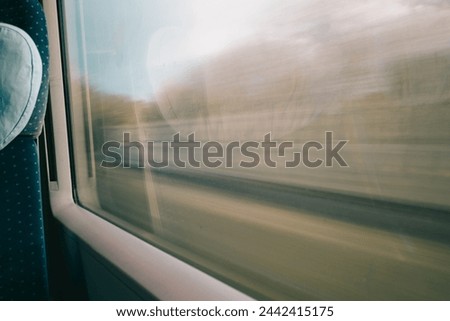 View from a moving train window with motion blur, capturing the essence of travel and speed.
