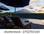 View of Mt. Agung and infinity pool in a tropical resort in Karangasem, Bali, Indonesia