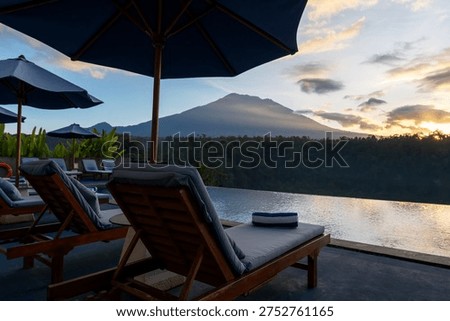 View of Mt. Agung and infinity pool in a tropical resort in Karangasem, Bali, Indonesia