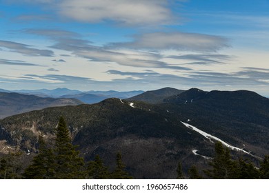 View From Mt. Mansfield Vermont At Stowe Ski Resort. Late Spring Time With Snow On The Mountains And Blue Sky.