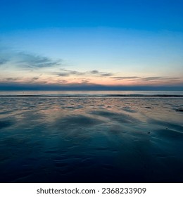 A view of the mudflats at Mallipo Beach in Korea. You can also see the horizon full of sunset. - Powered by Shutterstock