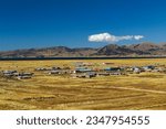 view of the Mulla Conti Hueco community and part of Lake Titicaca, in Ilave, Puno, Peru, from the stone forest where the Aramu Muru gate is located
