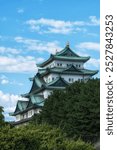 View of Nagoya Castle a famous iconic Japanese palace in between the pine trees. Taken in Nagoya, Japan