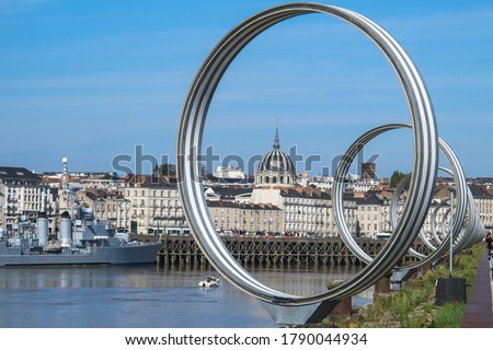 View of Nantes,France.Nantes panorama across Loire River.The Buren metal rings decoration. Sightseeing on Ile de Nantes.Beautiful European cityscape. French urban architecture