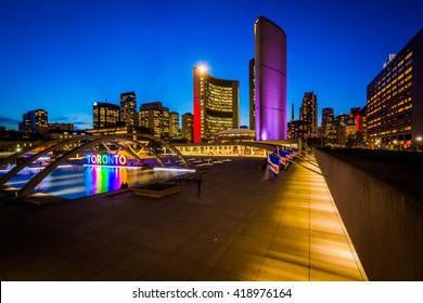 View of Nathan Phillips Square and Toronto Sign in downtown at night, in Toronto, Ontario.