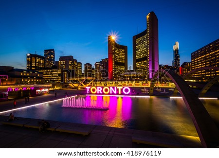 View of Nathan Phillips Square and Toronto Sign in downtown at night, in Toronto, Ontario.