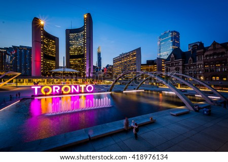 View of Nathan Phillips Square and Toronto Sign in downtown at twilight, in Toronto, Ontario.