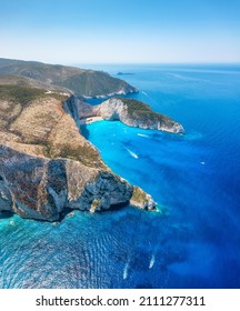 View of Navagio beach, Zakynthos Island, Greece. Aerial landscape. Azure sea water. Rocks and sea. Summer landscape from the air. - Shutterstock ID 2111277311